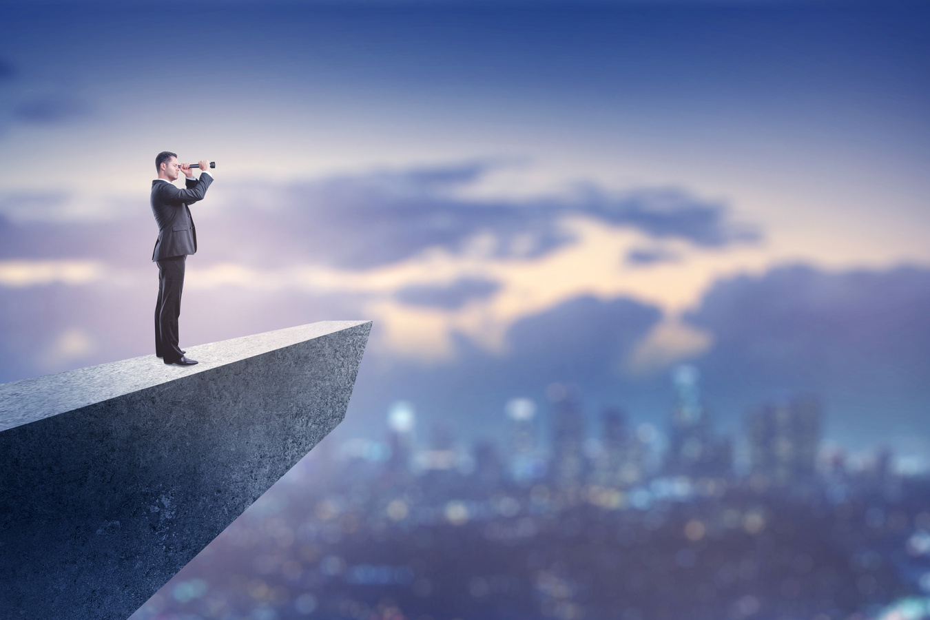 business vision concept with businessman on cliff